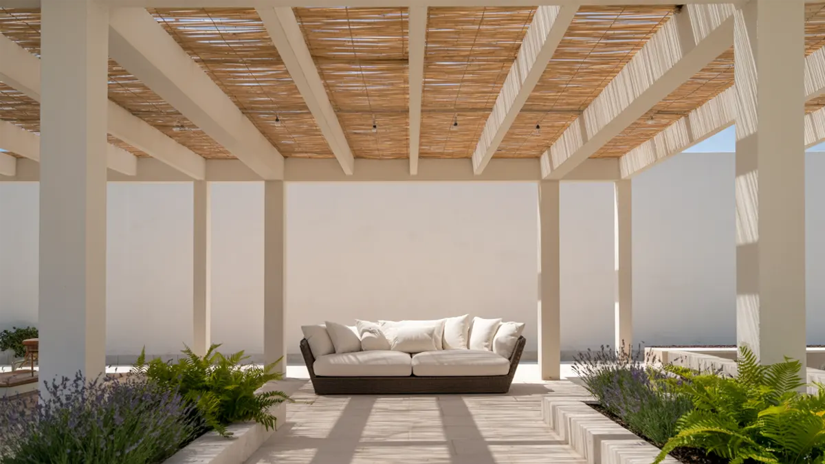 Outdoor patio with sofa and plants.