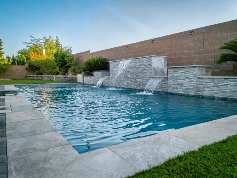 Backyard pool with three stone waterfalls